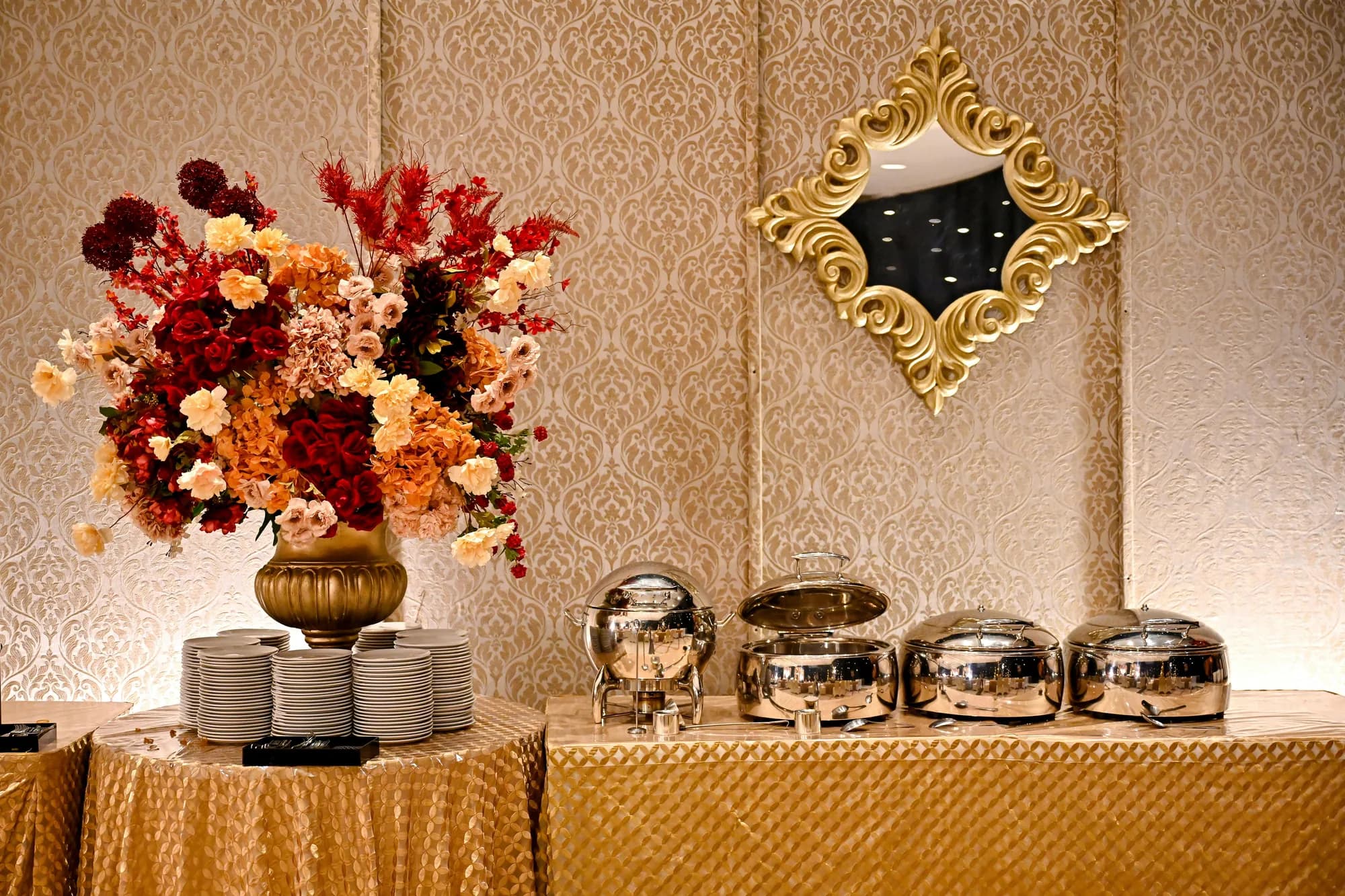 Premium wedding buffet laid out with chafing dishes and floral styling
