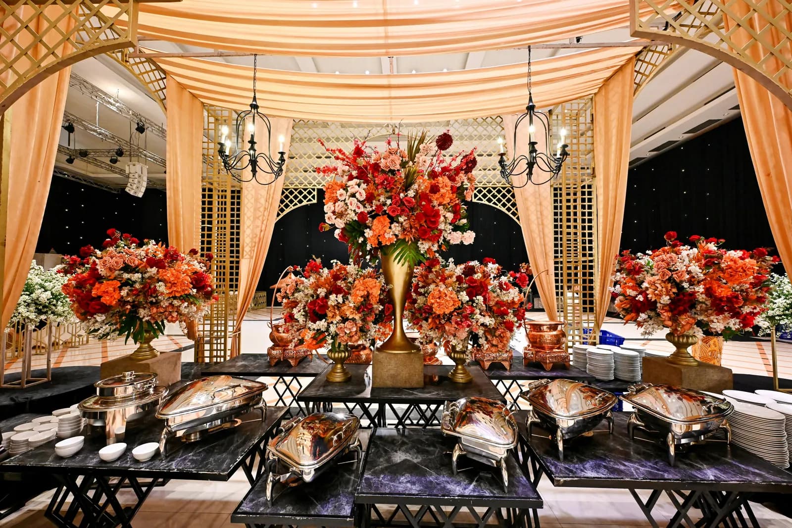 Wedding reception dining hall styled with florals and buffet counters